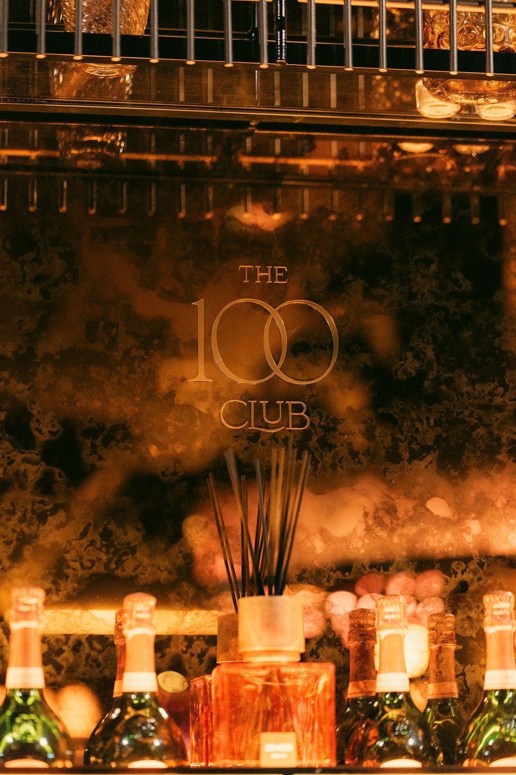 The 100 Club etched into the mirror behind the bar